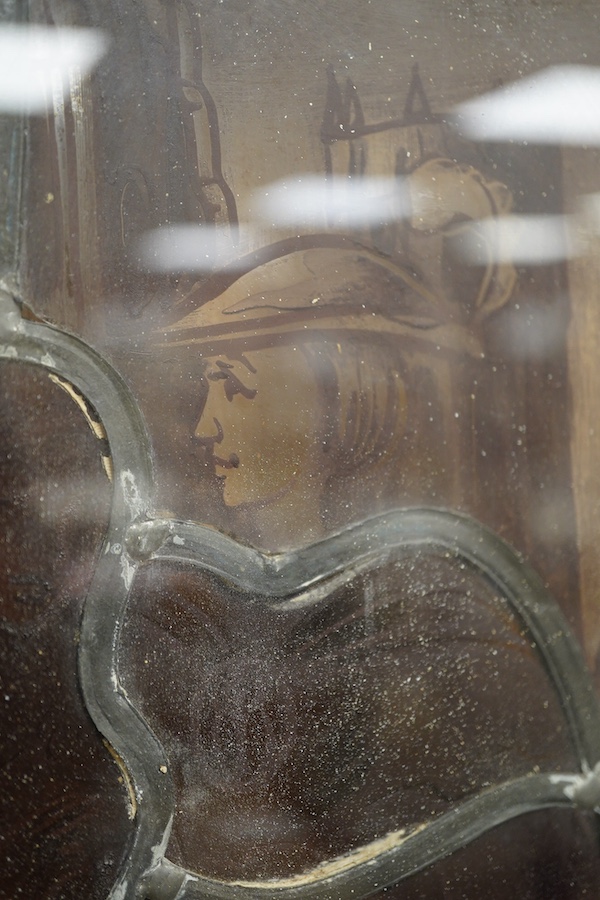 A stained and leaded glass panel of a romantic couple in front of a cathedral, 48cm high